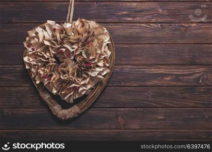 Valentine heart old book pages decoration on the wooden wall. Valentine heart decoration