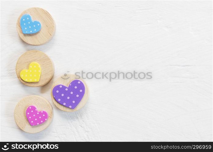 Valentine, love and wedding background concept. Colorful heart on white wood table. Picture for add text message. Backdrop for design art work. Sweet and pastel color tone.