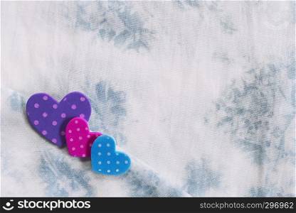 Valentine, love and wedding background concept. Colorful hearts on white fabric texture in vintage or retro color tone. Picture for add text message. Backdrop for design art work.