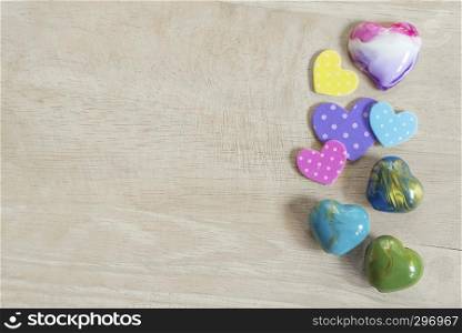 Valentine, love and wedding concept background. Colorful heart on wood table with free copy space. Vintage and retro. Picture for add text message. Backdrop for design art work.
