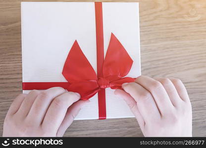 Valentine present. Gift box and red ribbon for romantic couple