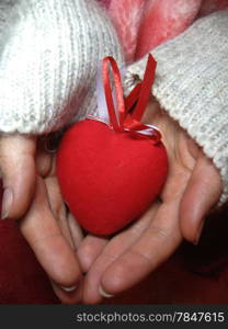 Valentine red heart in woman tender hands