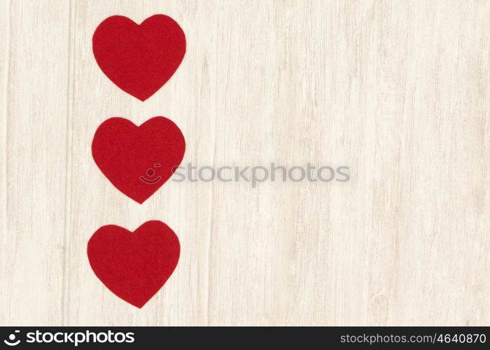 Valentine red hearts on grey wooden background