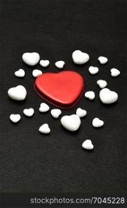 Valentine&rsquo;s Day. A red heart shape displayed on a black background with different size polystyrene hearts