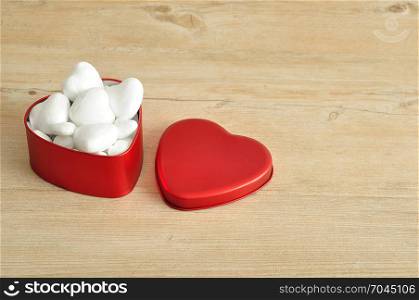 Valentine&rsquo;s Day. A red heart shape tin filled with with polystyrene hearts