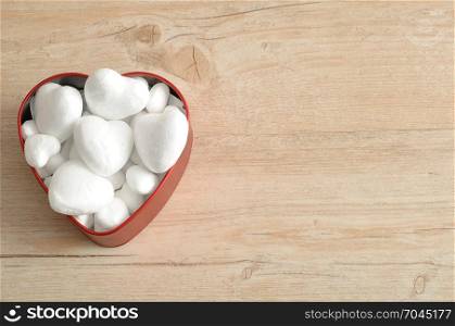 Valentine&rsquo;s Day. A red heart shape tin filled with with polystyrene hearts