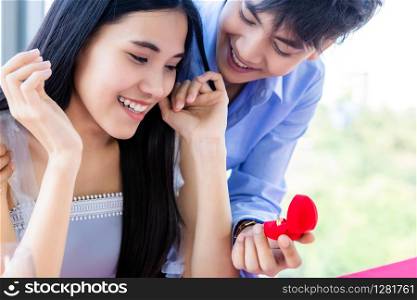 Valentine&rsquo;s day and asian Young happy sweet couple concept,asian a man with engagement ring making proposal of marriage to woman after lunch In a restaurant background, bride and groom wedding plans
