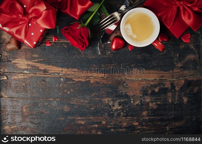 Valentine&rsquo;s day background with fresh cup of coffee, red roses, chocolate, fork, knife and gifts. Valentines day concept. Top view. Copy space.. Valentine&rsquo;s day background, flat lay