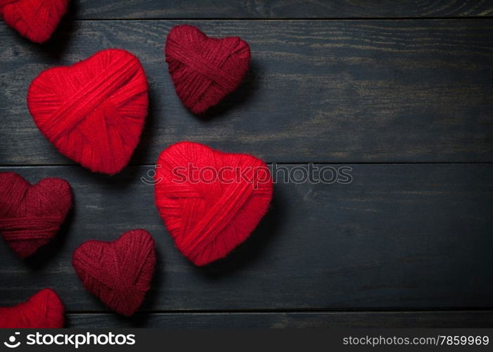 Valentine&rsquo;s Day background with hearts made of red wool. Copy space. Top view