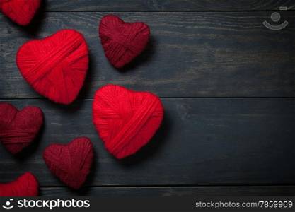 Valentine&rsquo;s Day background with hearts made of red wool. Copy space. Top view