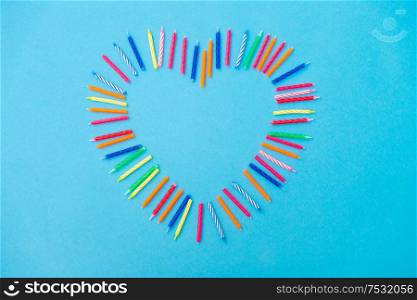 valentine&rsquo;s day, birthday and decoration concept - frame of cake candles in shape of heart. frame of birthday candles in shape of heart