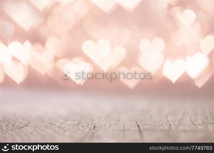 Valentine&rsquo;s Day bokeh pink lights hearts over wooden table background woth copy space for product. Valentine&rsquo;s Day bokeh hearts background