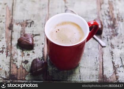 Valentine&rsquo;s day composition with coffee cup and chocolate on wooden background