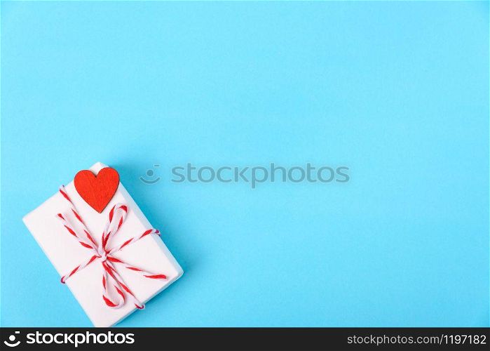 Valentine&rsquo;s day Concept, flat lay top view, White Gift Box and Red Heart on Blue background with copy space for your text