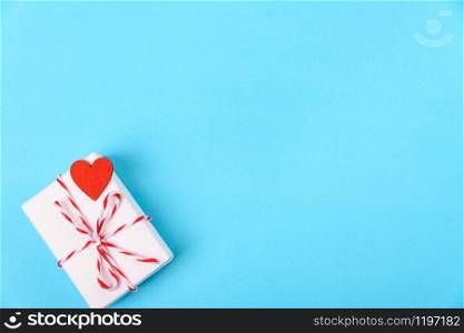 Valentine&rsquo;s day Concept, flat lay top view, White Gift Box and Red Heart on Blue background with copy space for your text