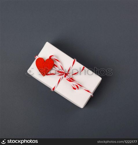 Valentine&rsquo;s day Concept, flat lay top view, White Gift Box and Red Heart on Gray background with copy space for your text