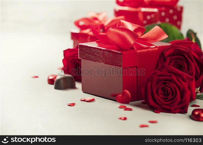Valentine's Day concept. Gift with red bow on the wooden background Valentines gift box tied with a red satin ribbon bow on rustic background.
