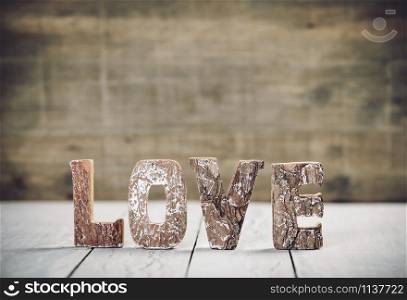 Valentine&rsquo;s Day concept. Love word letters. Love wood letters on table. Love wood letters close up.. Valentine&rsquo;s Day concept. Love wood letters on table. Love wood letters close up.