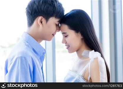 Valentine&rsquo;s day concept,portrait of asian Young happy couple face to face kissing at home background