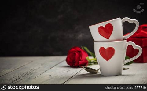 Valentine&rsquo;s Day concept. Red Cups and roses on a Wooden Background. Love or Valentine&rsquo;s Day Concept.. Valentine&rsquo;s Day concept. Cups and roses on a Wooden Background