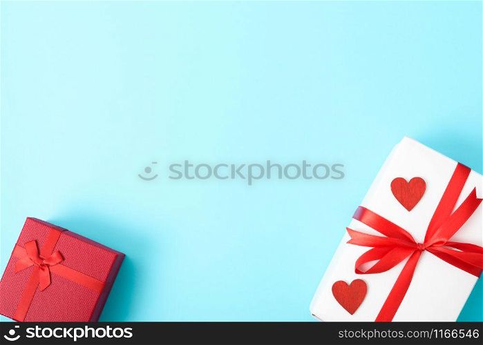 Valentine&rsquo;s Day Concept, Top view Flat lay, gift box and red heart on blue background with copy space for your text