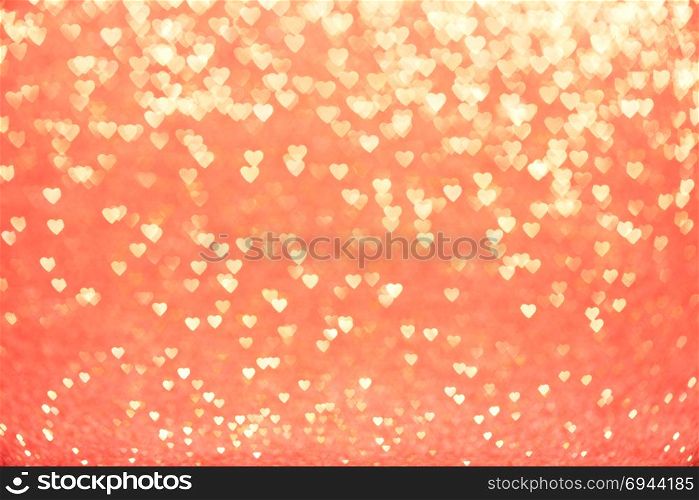 Valentine&rsquo;s Day Concept: Yellow Sparklng Defocused Romantic Hearts on the Red Background