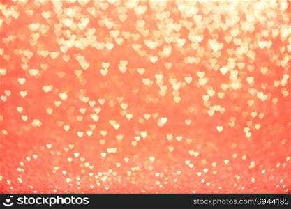 Valentine&rsquo;s Day Concept: Yellow Sparklng Defocused Romantic Hearts on the Red Background