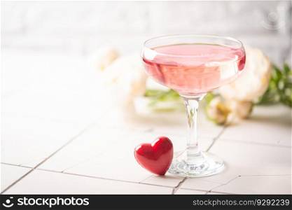 Valentine&rsquo;s day festive cocktail with flowers red heart on a festive white background. Valentine&rsquo;s day festive cocktail