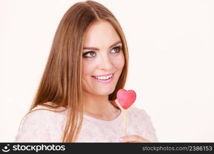 Valentine&rsquo;s day gift concept. Beautiful woman holding love sign, heart shaped wooden hand stick, studio shot on white background. Beautiful woman holding heart shaped hand stick