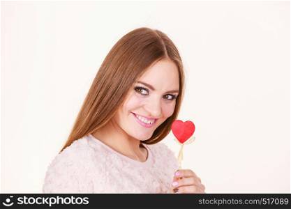 Valentine's day gift concept. Beautiful woman holding love sign, heart shaped wooden hand stick, studio shot on white background. Beautiful woman holding heart shaped hand stick