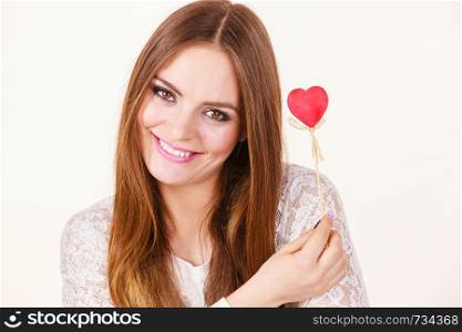 Valentine's day gift concept. Beautiful woman holding love sign, heart shaped wooden hand stick, studio shot on white background. Beautiful woman holding heart shaped hand stick