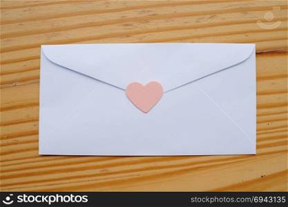 Valentine&rsquo;s day love letter envelope with hearts on wooden background. copy space