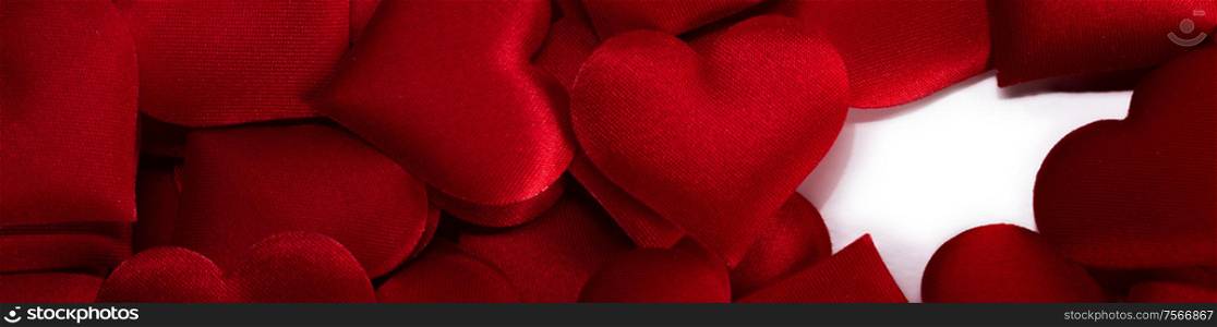Valentine&rsquo;s day many red silk hearts background and white copy space, love concept. Valentines day hearts background