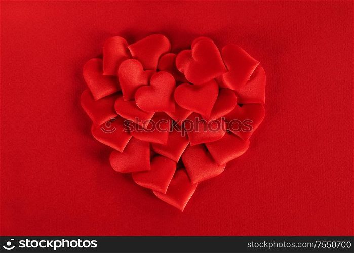 Valentine&rsquo;s day many red silk hearts ob paper background, love concept. Valentines day hearts background