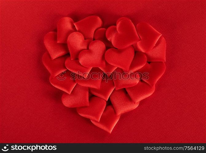 Valentine&rsquo;s day many red silk hearts ob paper background, love concept. Valentines day hearts background