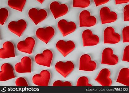 Valentine&rsquo;s day many red silk hearts on white background, love concept. Valentines day hearts on white