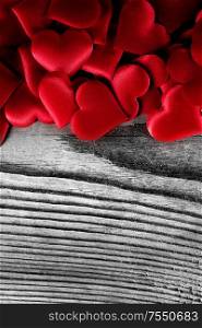 Valentine&rsquo;s day many red silk hearts on wooden background, love concept. Valentines day hearts background