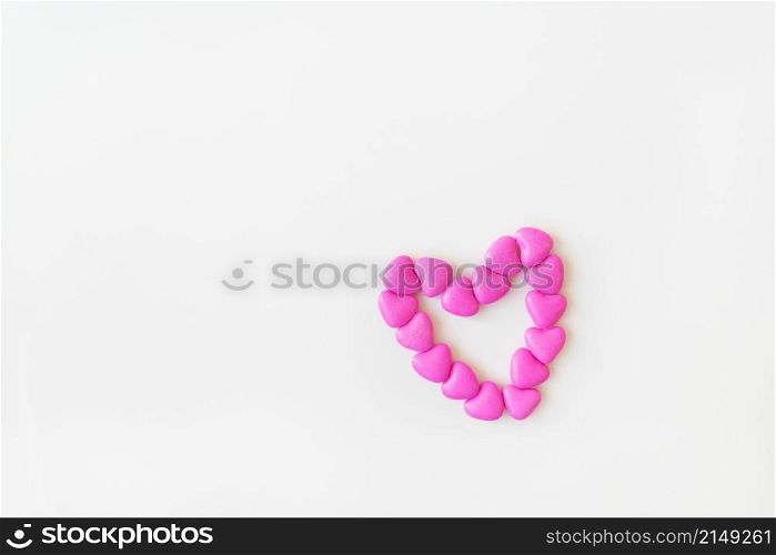 Valentine&rsquo;s day pattern background flat lay top view of heart shaped pink candies scattered on white background. Place for an inscription. Valentine&rsquo;s day pattern background flat lay top view of heart shaped pink candies scattered on white background. Place for an inscription.