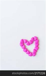Valentine&rsquo;s day pattern background flat lay top view of heart shaped pink candies scattered on white background. Valentine&rsquo;s day pattern background flat lay top view of heart shaped pink candies scattered on white background.