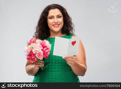 valentine&rsquo;s day, people and love concept - happy woman with flower bunch and greeting card over grey background. happy woman with flower bunch and greeting card