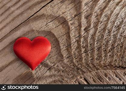 Valentine&rsquo;s day red silk heart on wooden background, love concept. Valentines day heart on wood