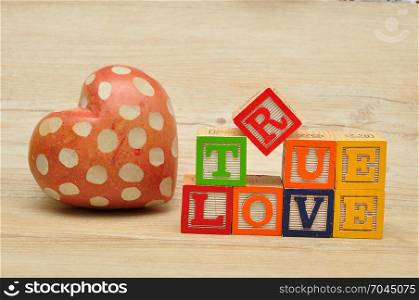 Valentine&rsquo;s Day. True love spelled with colorful alphabet blocks and a red heart