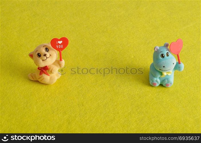 Valentine&rsquo;s day. Two figurines holding hearts