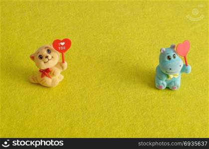 Valentine&rsquo;s day. Two figurines holding hearts