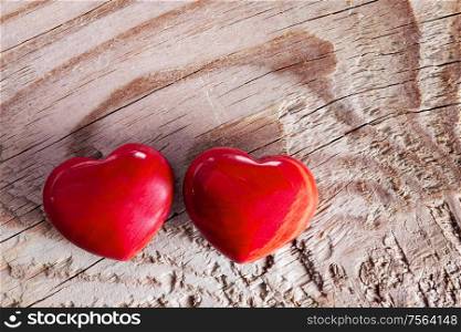 Valentine&rsquo;s day two red hearts on wooden background macro, love concept. Valentines day hearts on wood