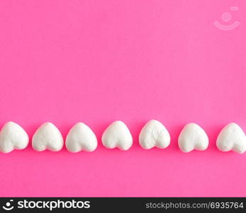 Valentine&rsquo;s Day. White polystyrene hearts on a pink background