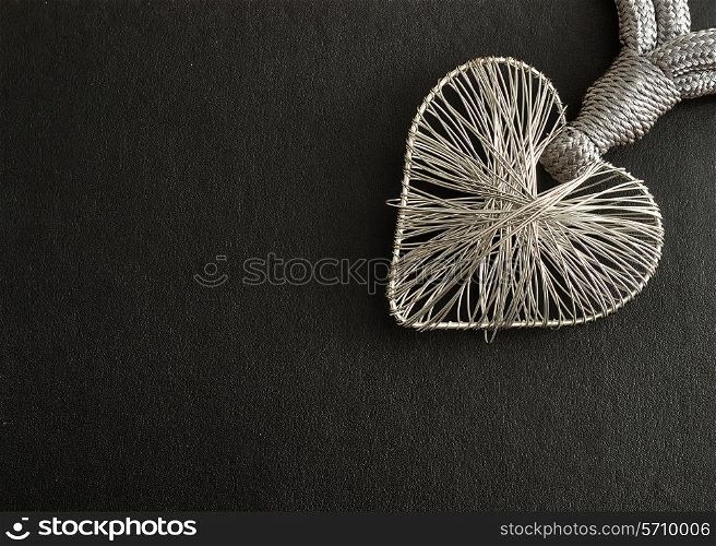 Valentine's Day. A heart made out of silver on a black background