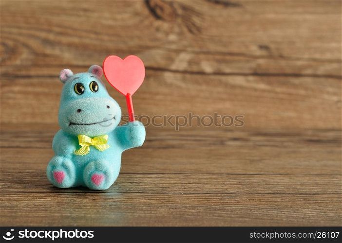 Valentine's day. A hippo figurine holding a red heart