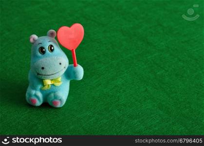 Valentine's day. A hippo figurine holding a red heart