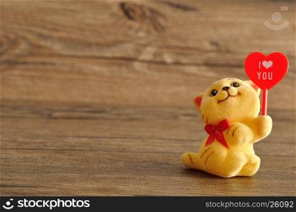 Valentine's day. A kitten figurine holding a red heart